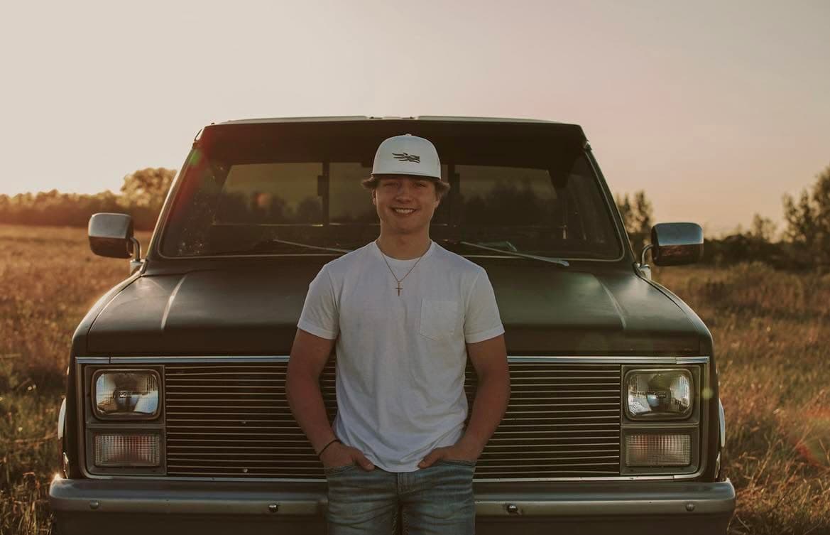 CM Roofing owner Cade Martin standing in front of a truck