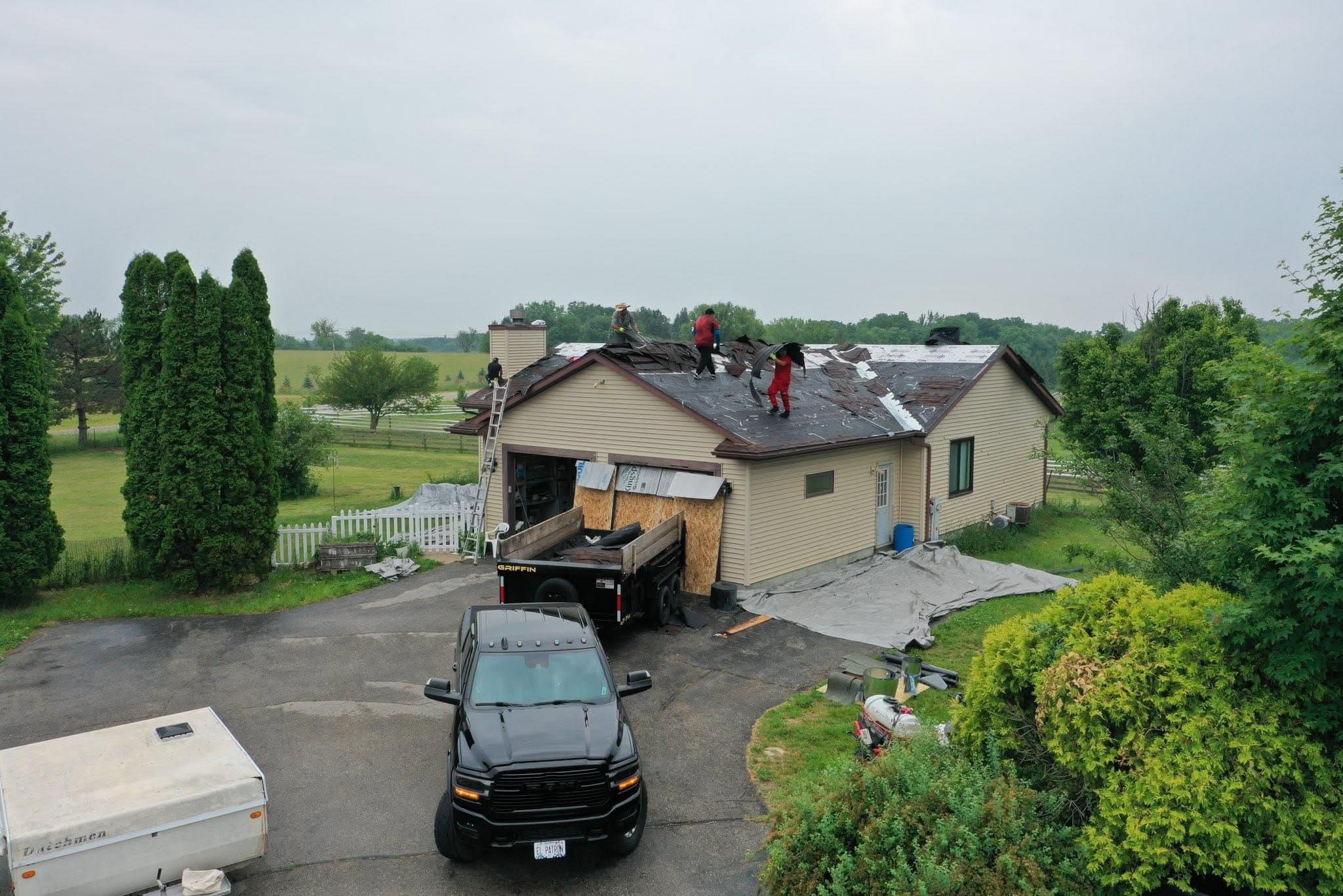 Roofing crew working on a residential shingle tear-off