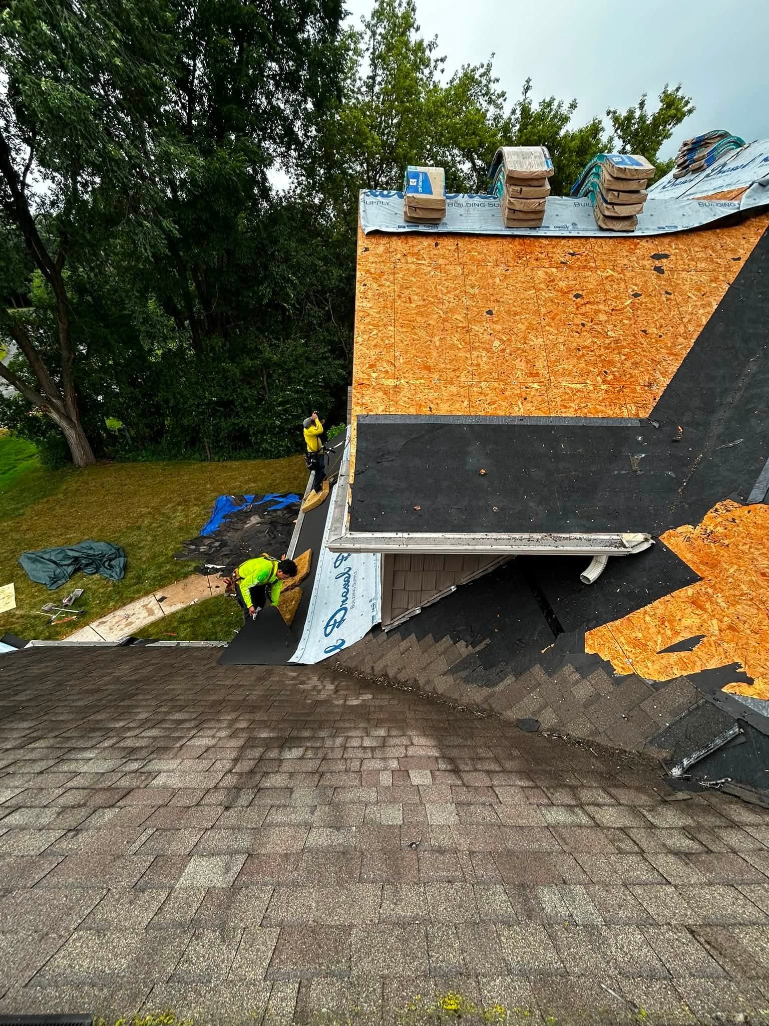 Exposed roof decking and underlayment during a CM Roofing project