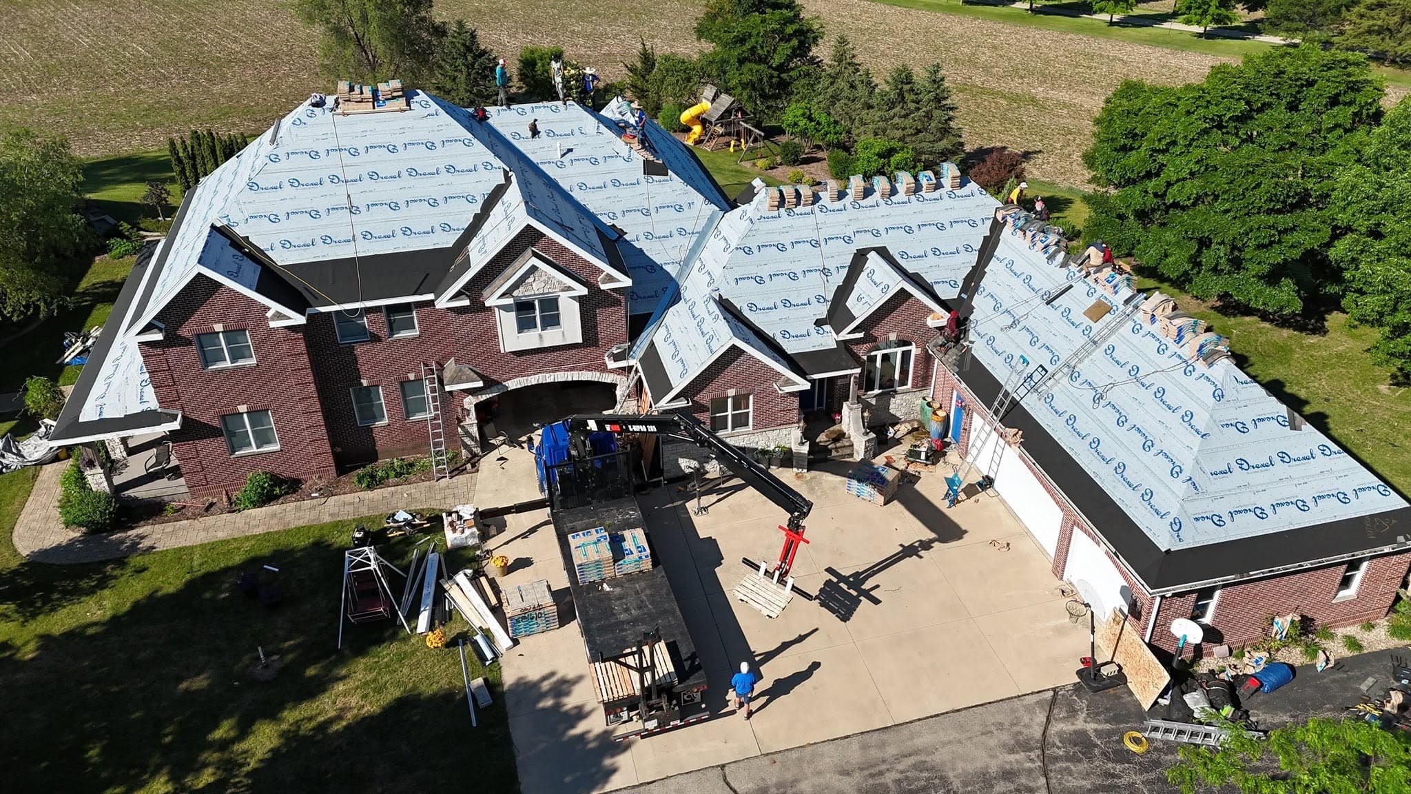 Aerial view of a large residential roof installation in progress