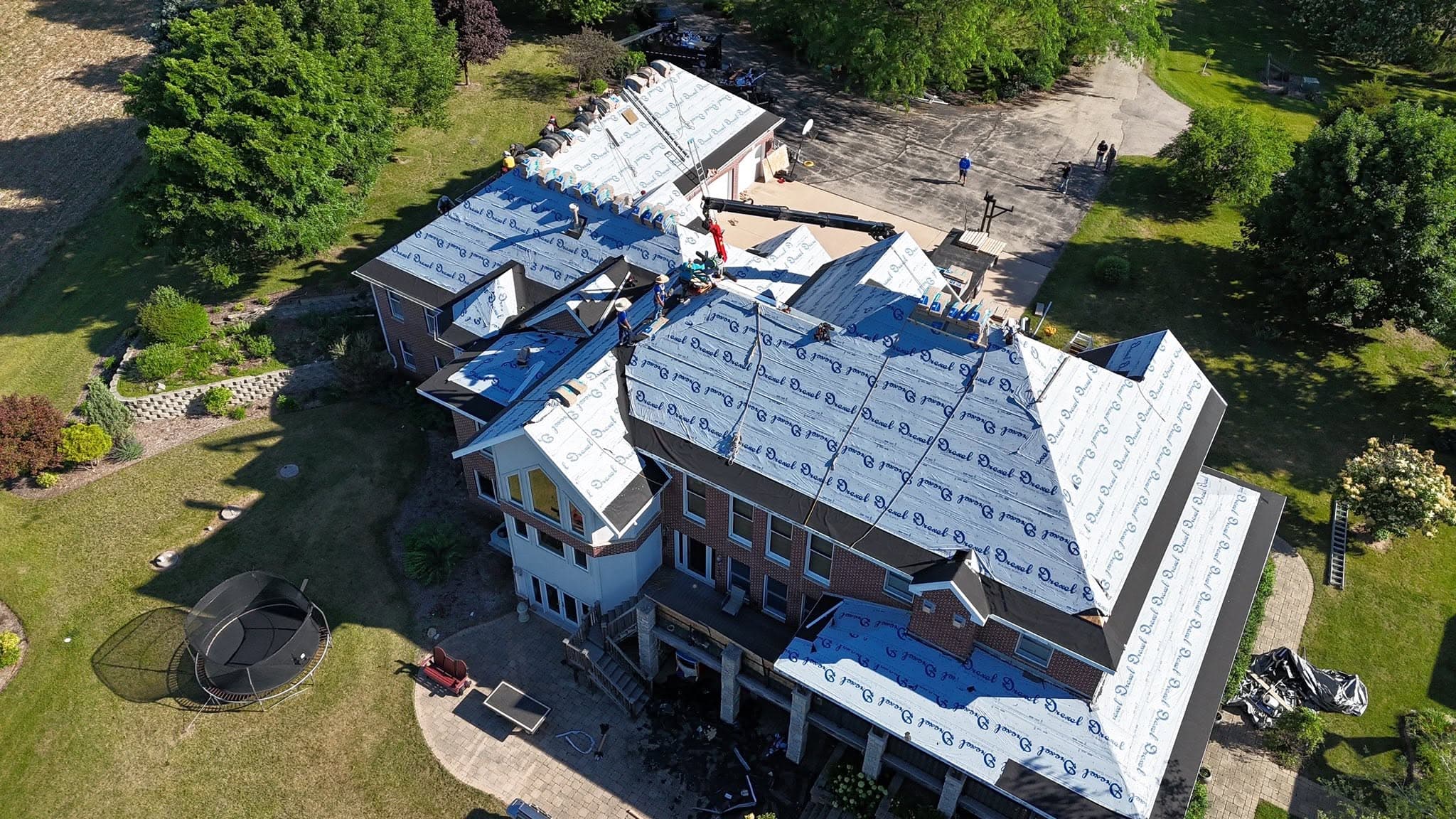 Aerial view of a residential roofing installation in progress