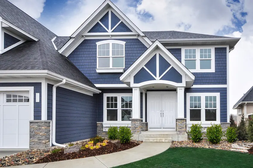 Blue siding and white trim on a finished home exterior